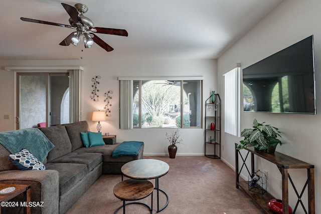 carpeted living room with french doors and ceiling fan