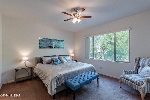 bedroom featuring dark colored carpet and ceiling fan