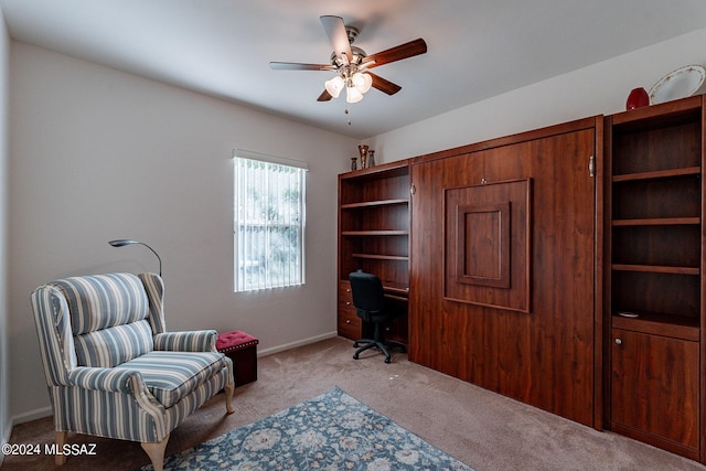 home office with ceiling fan and light carpet