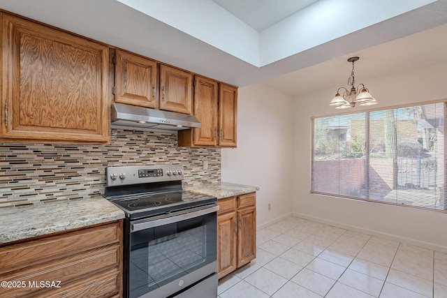 kitchen featuring stainless steel range with electric cooktop, an inviting chandelier, light stone countertops, tasteful backsplash, and light tile patterned flooring