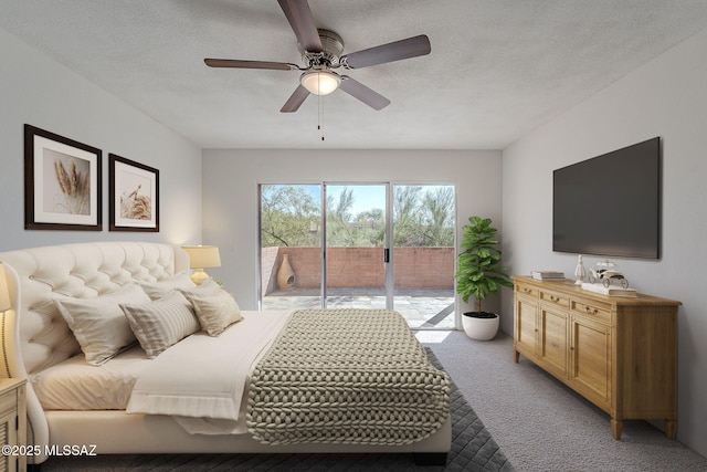 carpeted bedroom featuring ceiling fan, access to exterior, and a textured ceiling