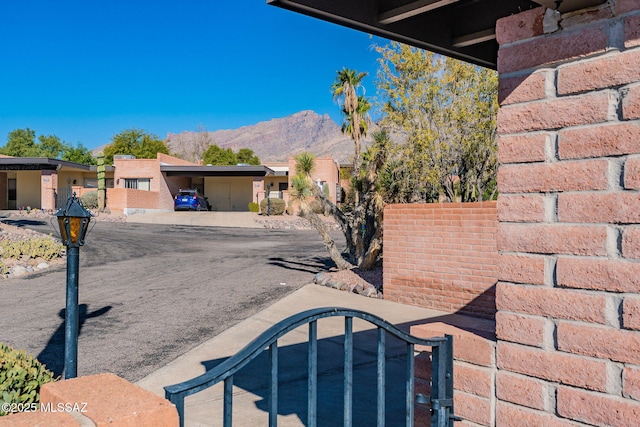 view of road with a mountain view and driveway