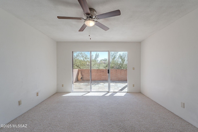 empty room with a textured ceiling, carpet flooring, and a ceiling fan