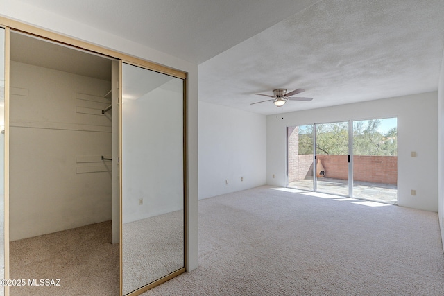 interior space with access to outside, ceiling fan, a closet, and light carpet