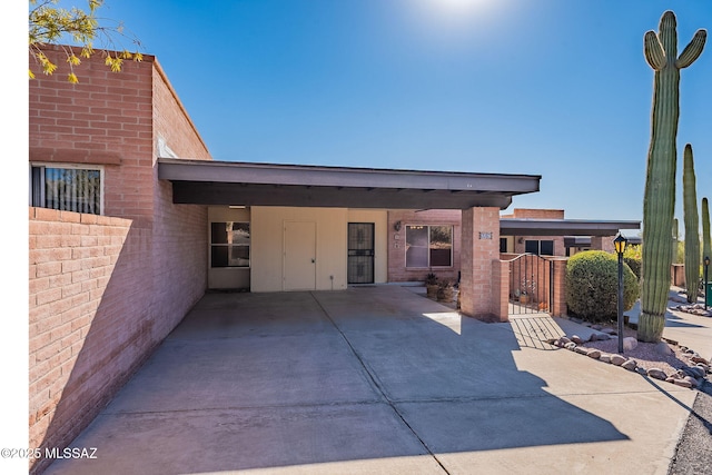 view of patio / terrace with a gate, fence, and an attached carport