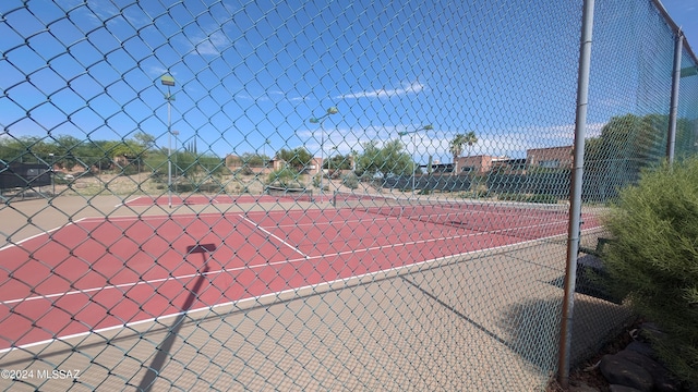 view of sport court featuring fence