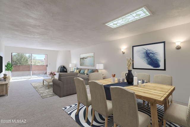 dining space with carpet floors and a textured ceiling