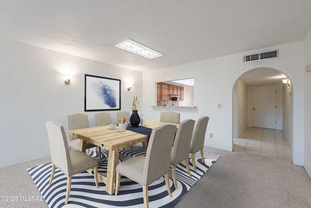 dining area featuring light colored carpet