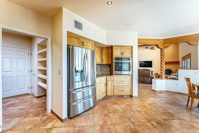 kitchen featuring backsplash, ceiling fan, and stainless steel appliances