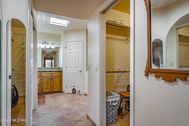 bathroom featuring a skylight and vanity