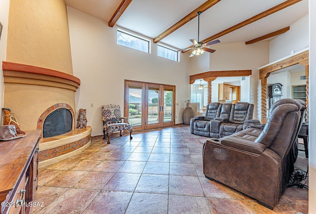 living room with beamed ceiling, french doors, ceiling fan, and a high ceiling