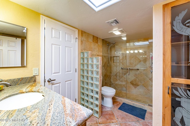 bathroom featuring walk in shower, tile patterned flooring, a textured ceiling, toilet, and vanity