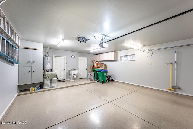 garage featuring gas water heater and a garage door opener