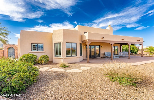 rear view of property featuring a patio