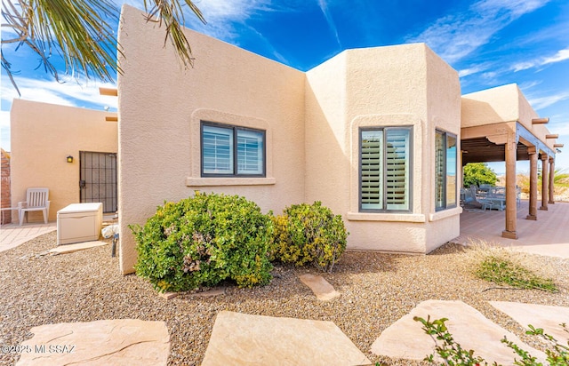 view of side of home with a patio