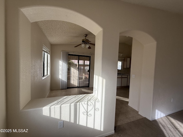 hallway featuring carpet floors and a textured ceiling