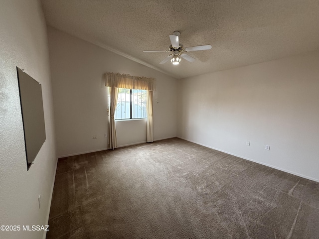 empty room featuring a textured ceiling, ceiling fan, carpet flooring, and lofted ceiling