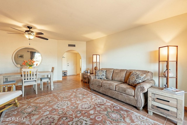 living room featuring light tile patterned floors and ceiling fan