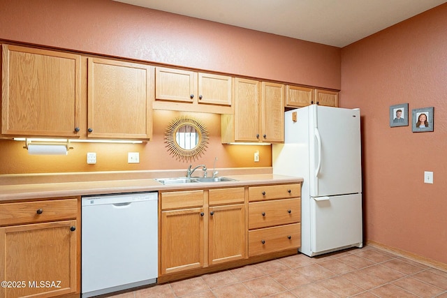 kitchen featuring light tile patterned floors, white appliances, sink, and light brown cabinetry