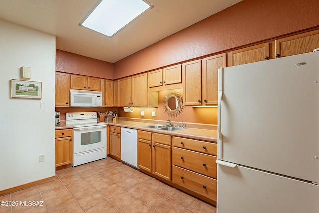 kitchen with light tile patterned flooring, white appliances, and sink