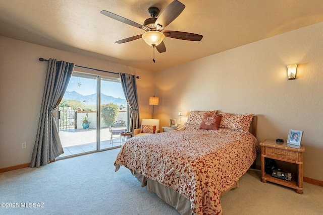 carpeted bedroom featuring access to exterior, a mountain view, and ceiling fan