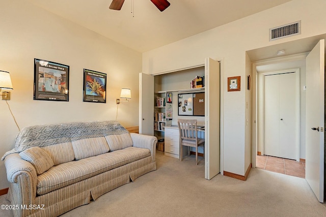 carpeted living room with ceiling fan