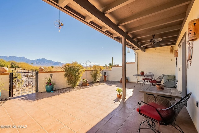 view of patio / terrace featuring a mountain view and ceiling fan