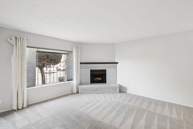 unfurnished living room with light colored carpet and a brick fireplace