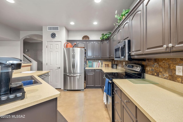 kitchen featuring visible vents, backsplash, light countertops, recessed lighting, and stainless steel appliances