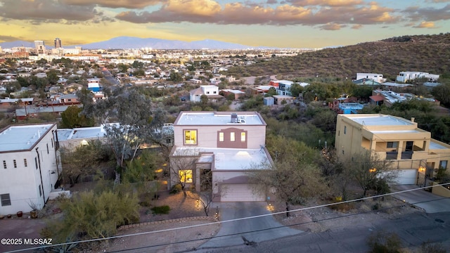 aerial view at dusk featuring a mountain view