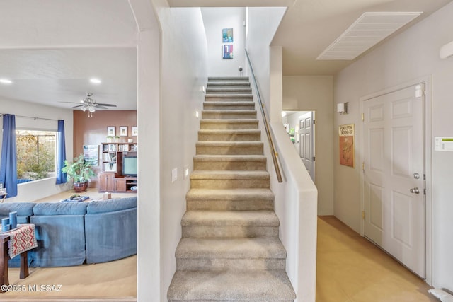 stairway featuring visible vents and ceiling fan