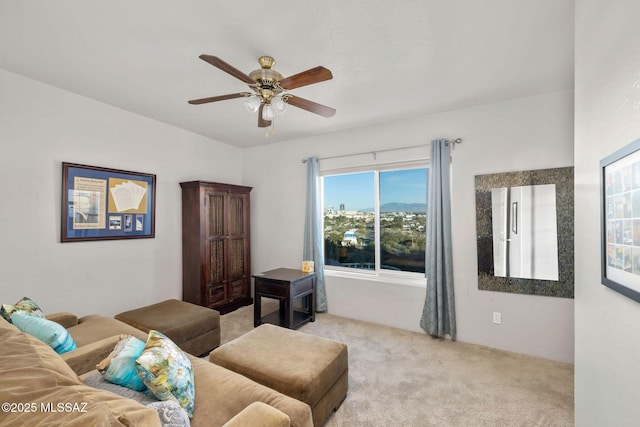 living area featuring ceiling fan and carpet