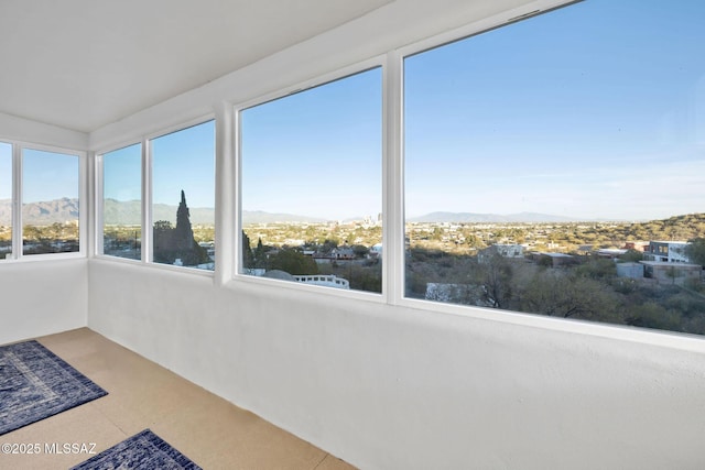 unfurnished sunroom featuring a mountain view