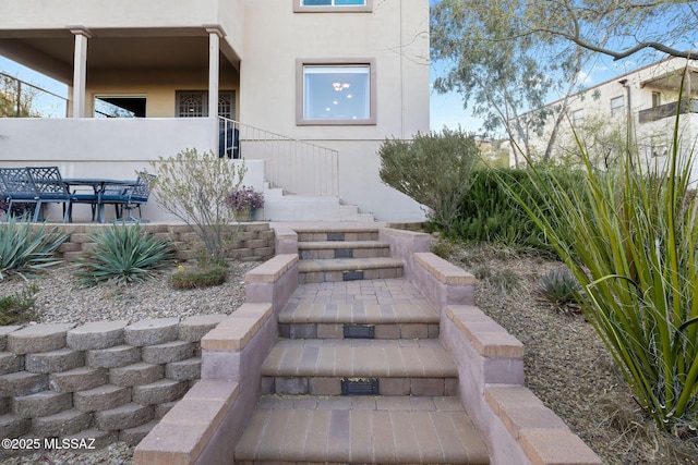 view of exterior entry with stucco siding