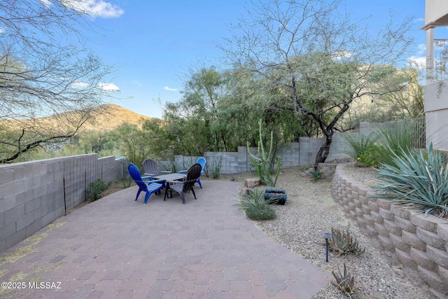 view of patio featuring a fenced backyard and a mountain view