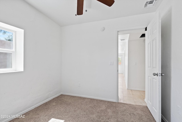 empty room with ceiling fan and light colored carpet