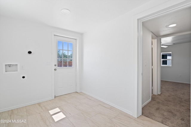 view of carpeted foyer entrance