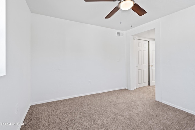 carpeted empty room with ceiling fan