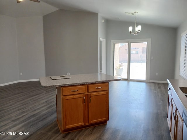 kitchen with dark wood-style floors, pendant lighting, lofted ceiling, visible vents, and open floor plan