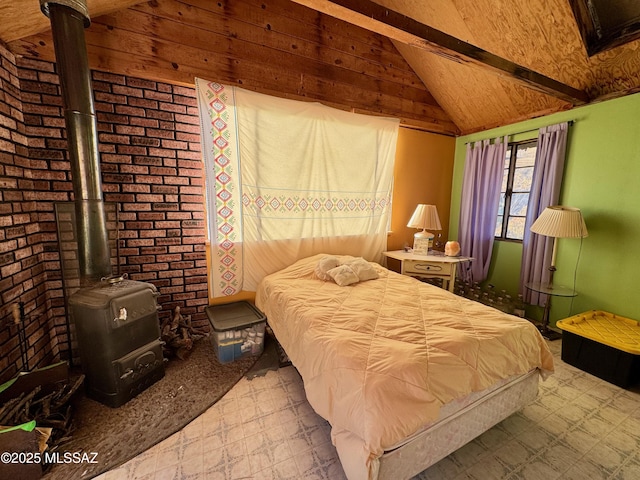 bedroom with brick wall, lofted ceiling, and a wood stove