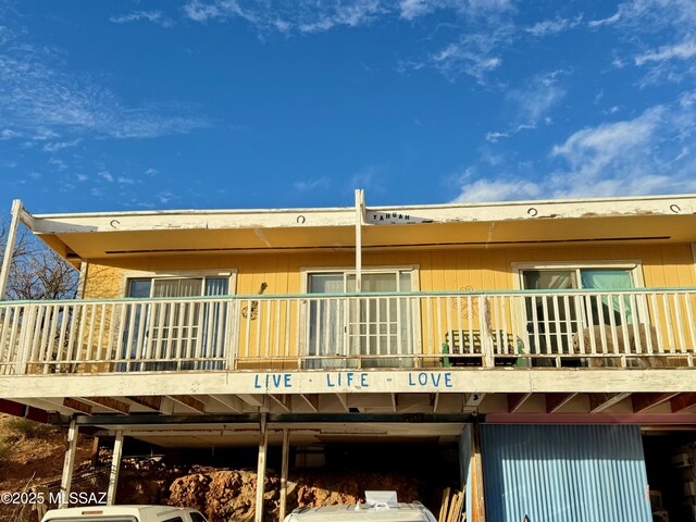 view of side of home featuring a balcony