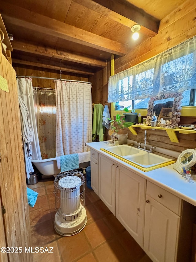 bathroom featuring wood ceiling, a bathtub, wooden walls, vanity, and beamed ceiling