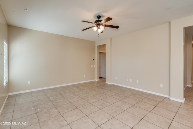 tiled empty room featuring ceiling fan