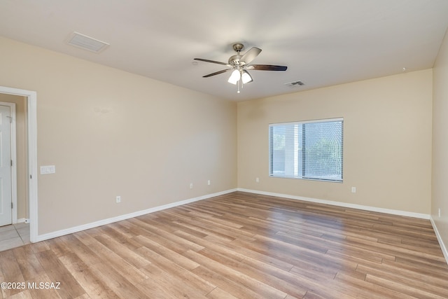 spare room with ceiling fan and light wood-type flooring