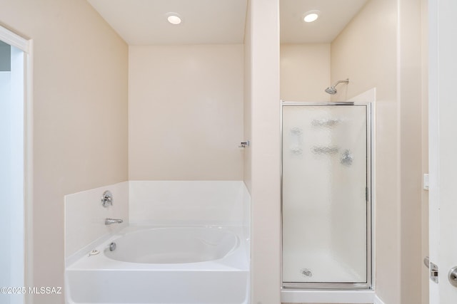 bathroom featuring separate shower and tub