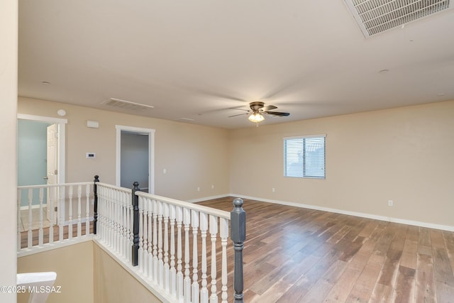 empty room with wood-type flooring and ceiling fan