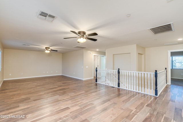 unfurnished room featuring ceiling fan and light hardwood / wood-style floors