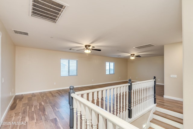 hallway with hardwood / wood-style floors