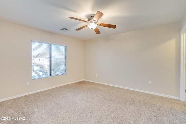 carpeted spare room featuring ceiling fan