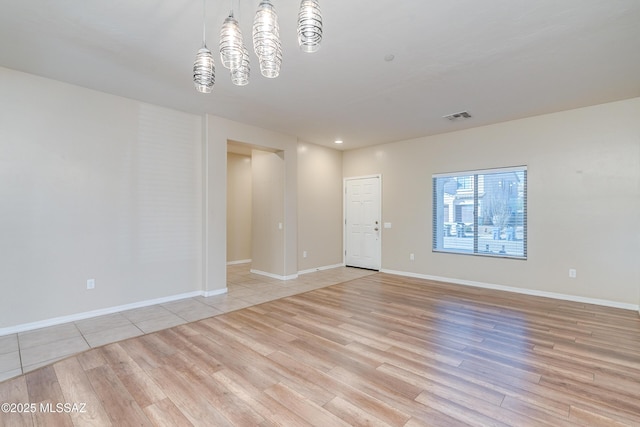 spare room featuring light hardwood / wood-style flooring